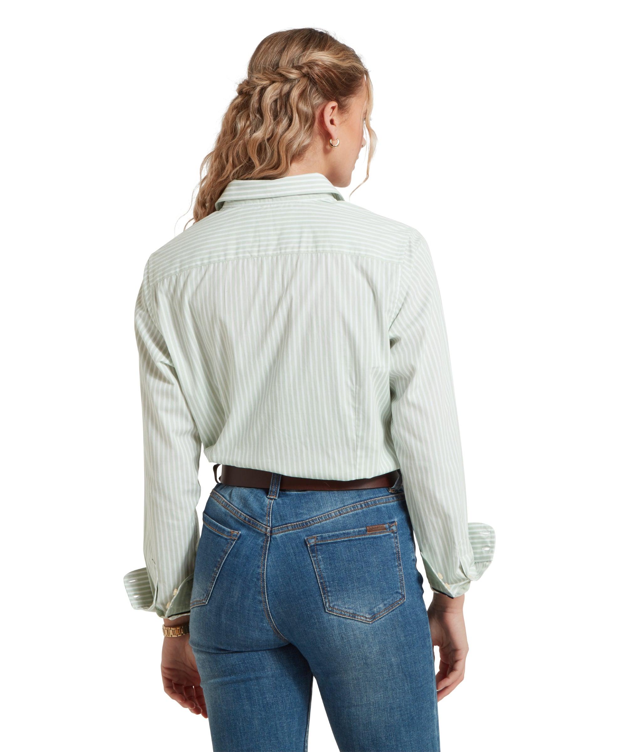 Back image of a female model wearing a green and white striped Schöffel shirt, paired with mid denim jeans and a tan leather belt. She is standing in a relaxed pose with her hands by her side.