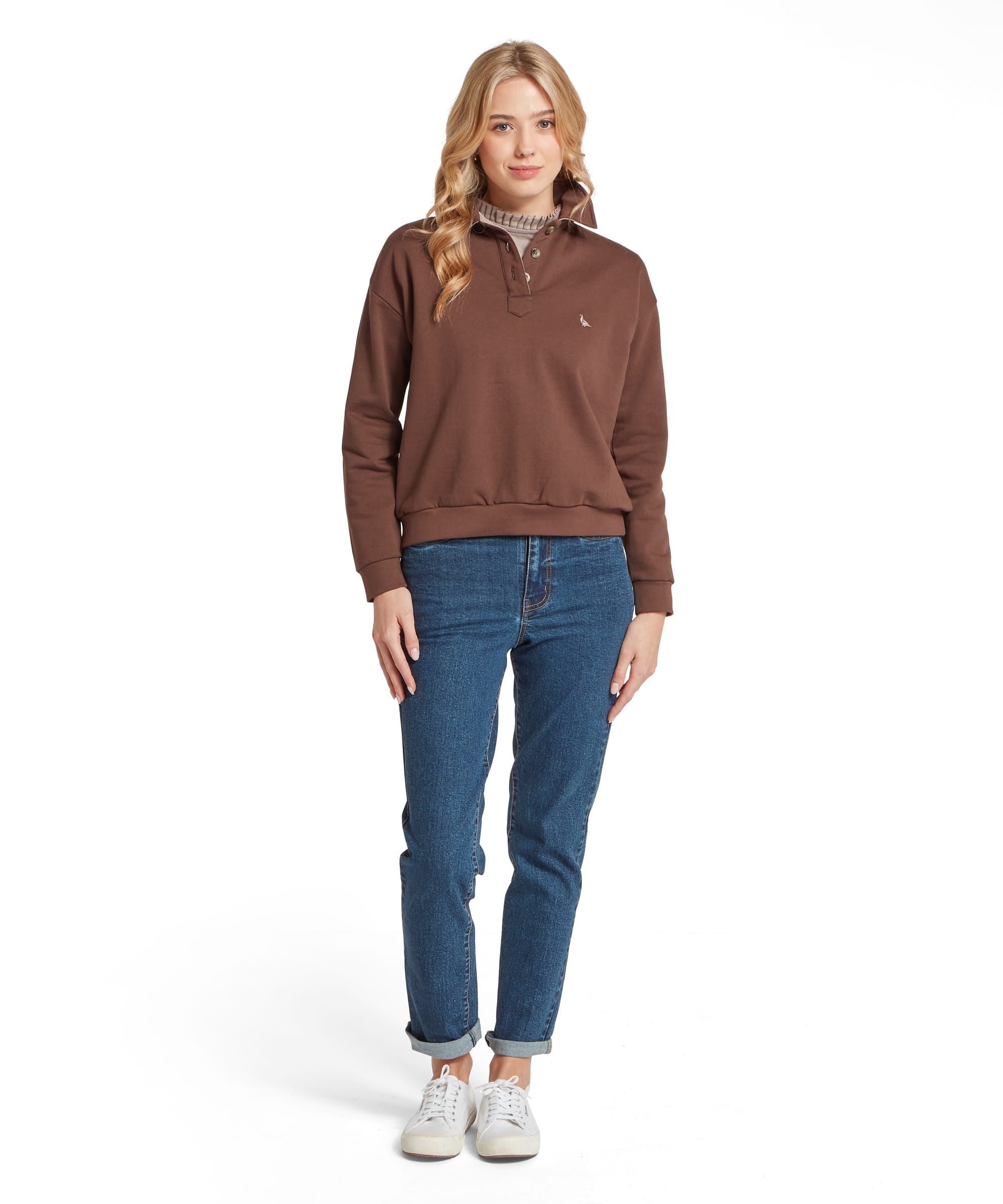 Schöffel Women's Horseley Rugby Sweatshirt in dark chocolate brown, full-length front view with snap-button placket collar and embroidered pheasant logo on chest, styled with blue jeans and white trainers