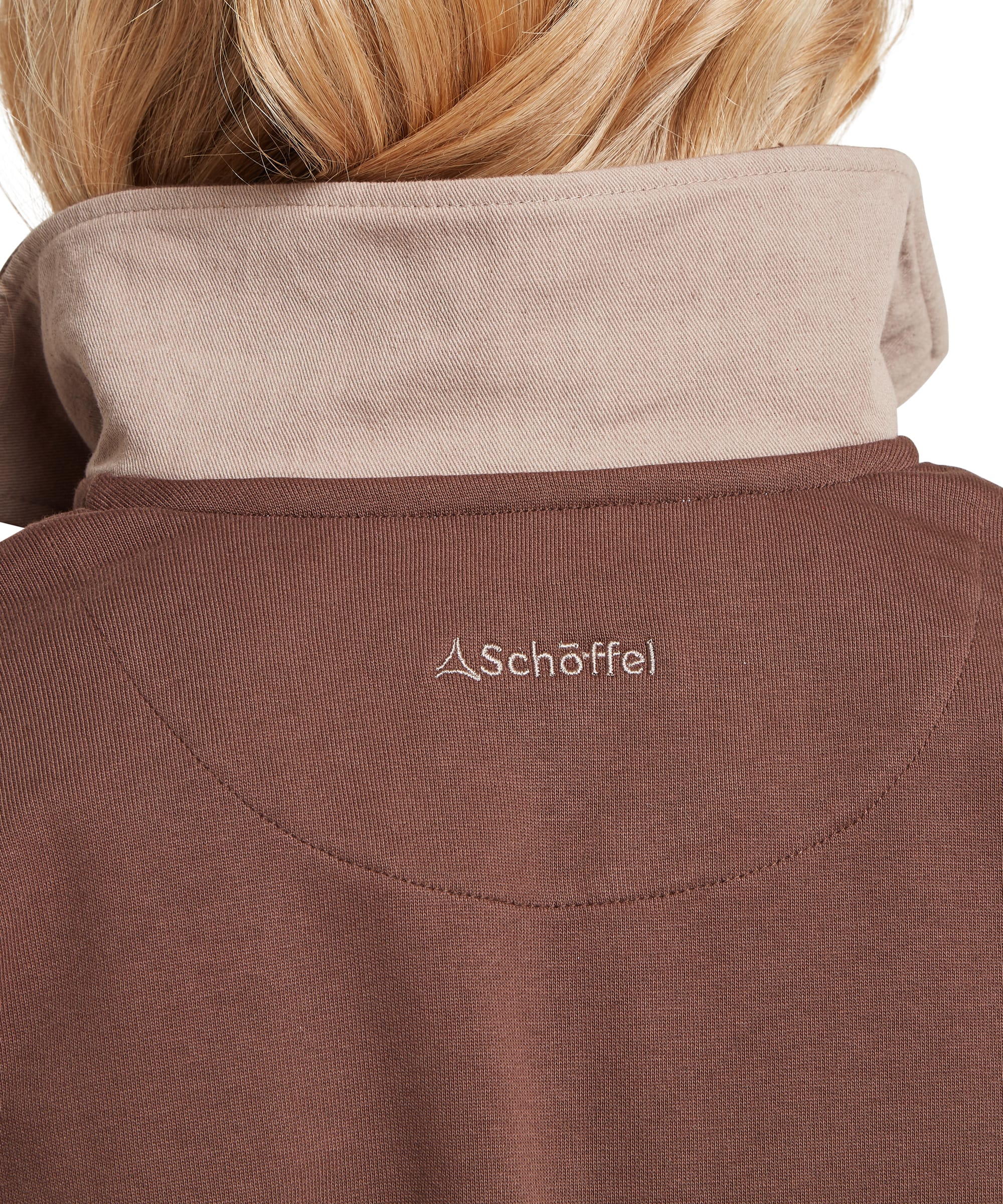 Close-up rear neck detail of the Schöffel Women's Horseley Rugby Sweatshirt in brown, showing the contrast stone-coloured inner collar and embroidered Schöffel logo on the upper back
