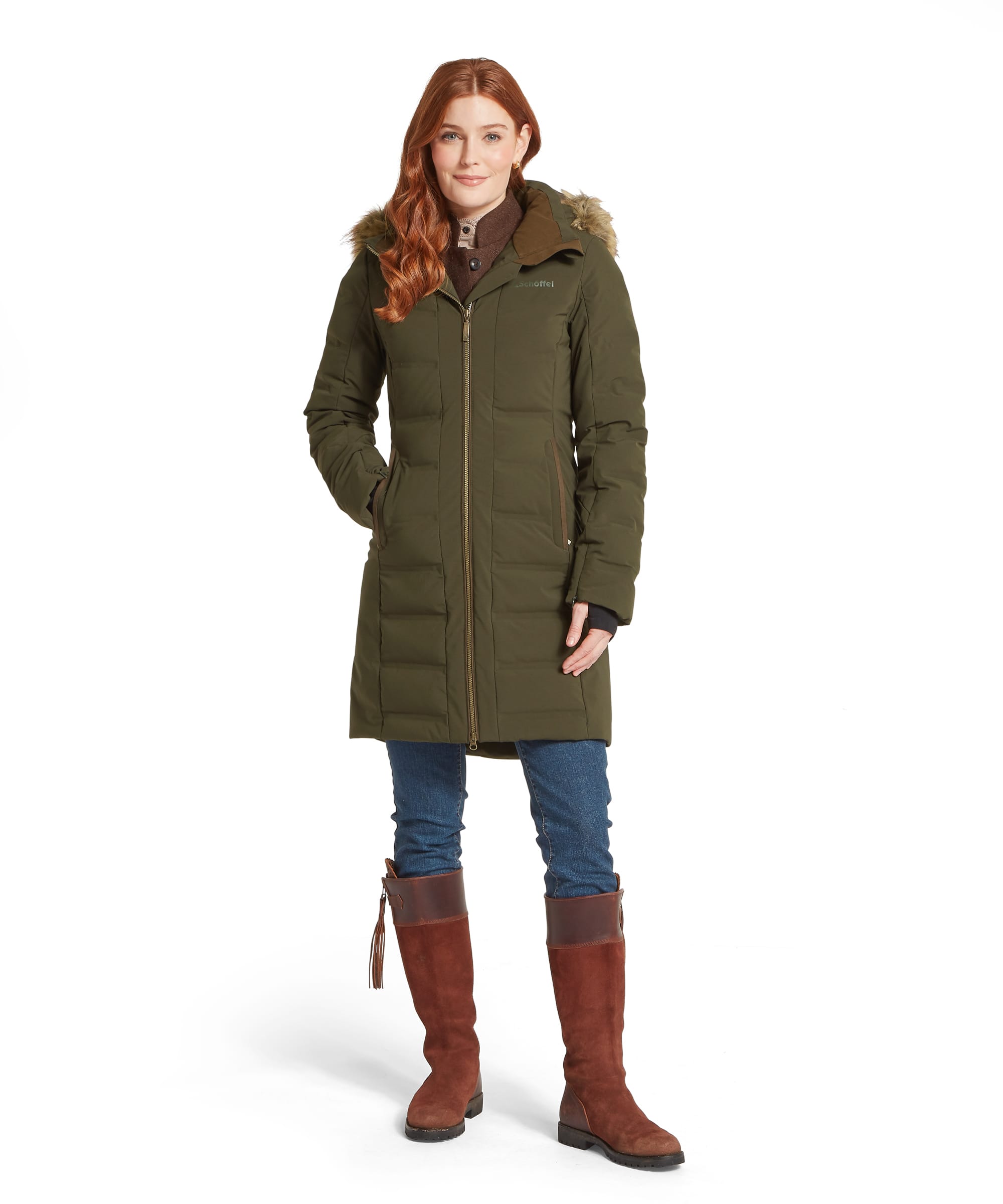 Schöffel Women's Hurlingham Waterproof Down Coat in olive green, full-length front view with faux fur-trimmed hood, gold zip fastening, horizontal quilted baffles and knitted inner cuffs, styled with blue jeans and tan leather knee-high boots