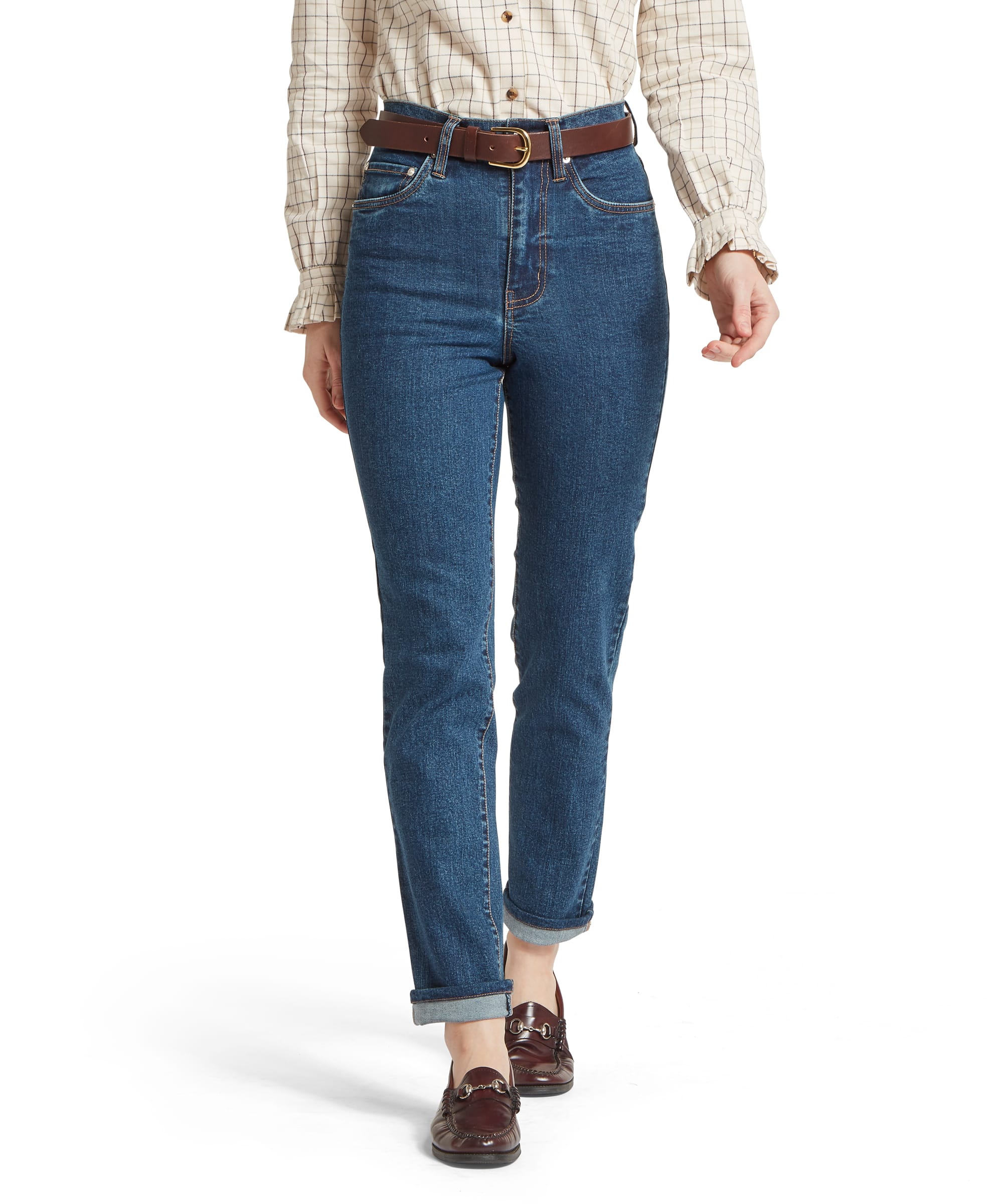 Schöffel Women's Ivy Jean in mid blue denim, cropped front view showing high-rise waistband with brown leather belt, five-pocket styling with contrast stitching, worn with a cream windowpane-check shirt and horsebit loafers