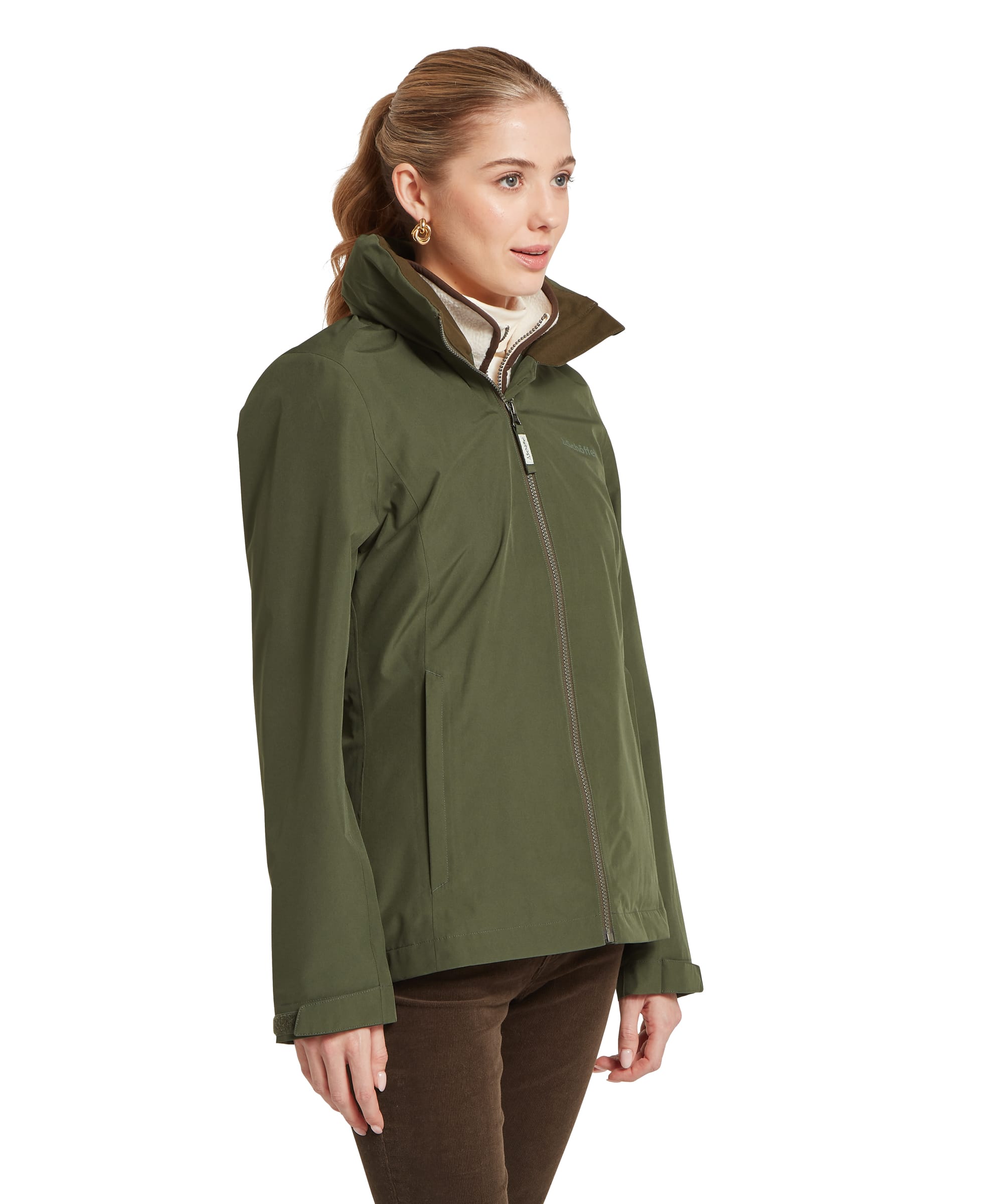 Side profile of the Schöffel Women's Manton Lightweight Waterproof Jacket in Dark Olive, highlighting the tailored cut, storm collar and practical side pockets, layered over a fleece mid-layer