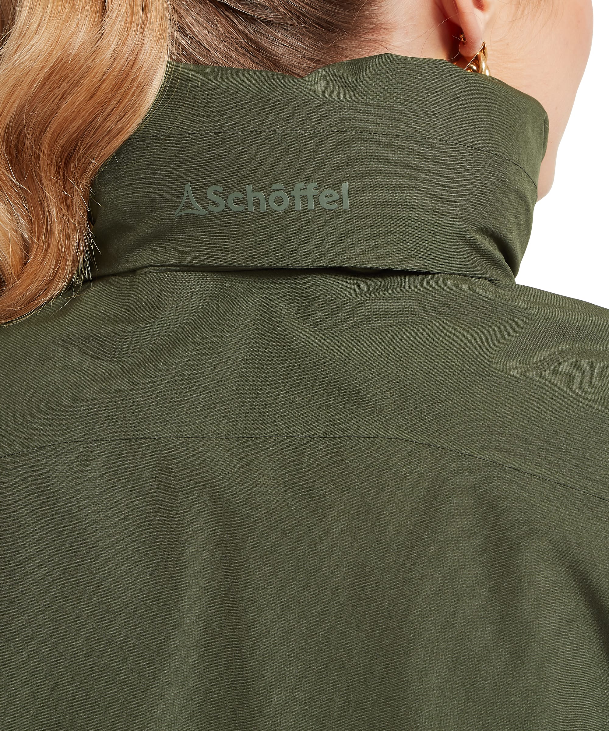Close-up rear detail of the Women's Schöffel Manton Lightweight Jacket in dark olive green, showing the tonal embroidered Schöffel logo at the back of the stand collar and the clean back seaming of the waterproof shell fabric.
