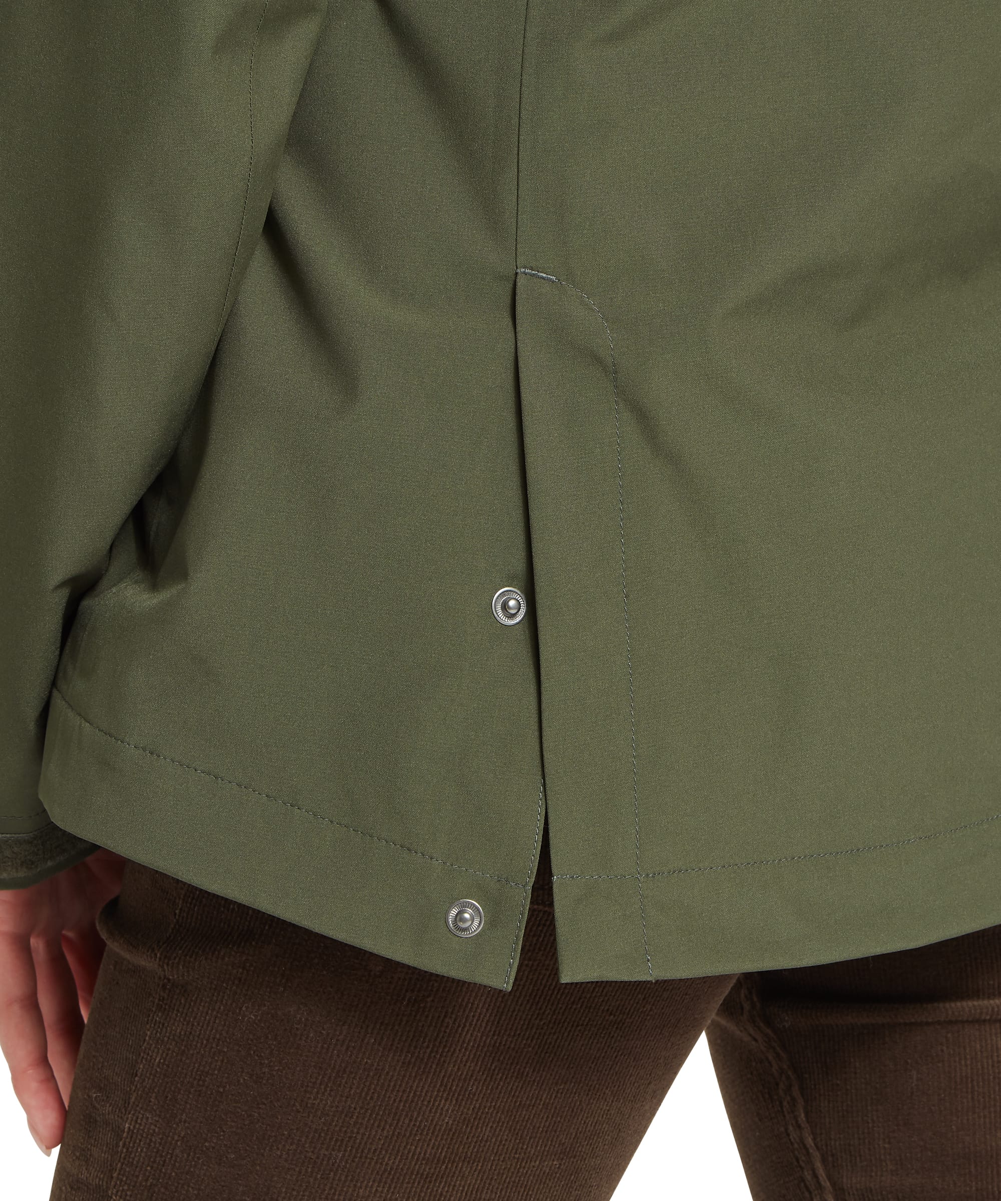 Close-up rear detail of the Women's Schöffel Manton Lightweight Jacket in dark olive green, showing the side hem vent with Schöffel branded press studs, storm flap and the clean waterproof shell construction of the jacket.