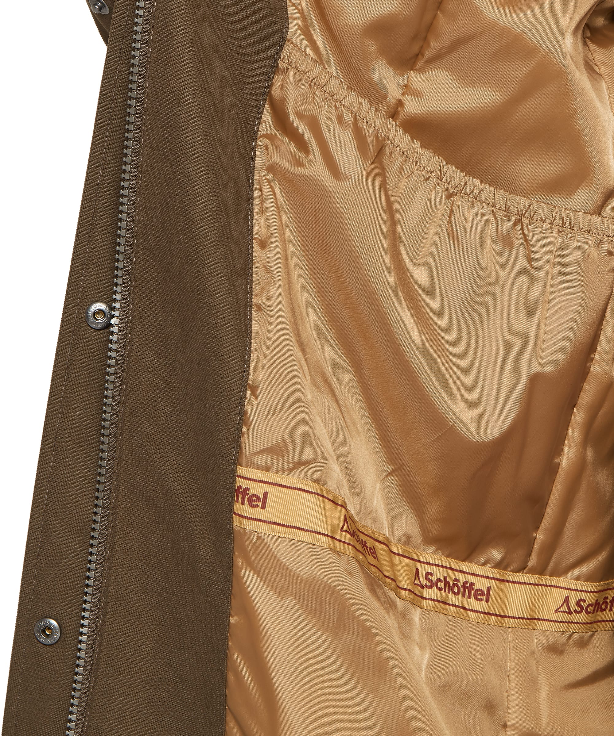 Interior lining detail of the Schöffel Women's Marefield Waterproof Coat in khaki green, showing the warm caramel satin lining with internal zip pocket, elasticated waist adjustment, and Schöffel branded woven label repeated along the drawcord