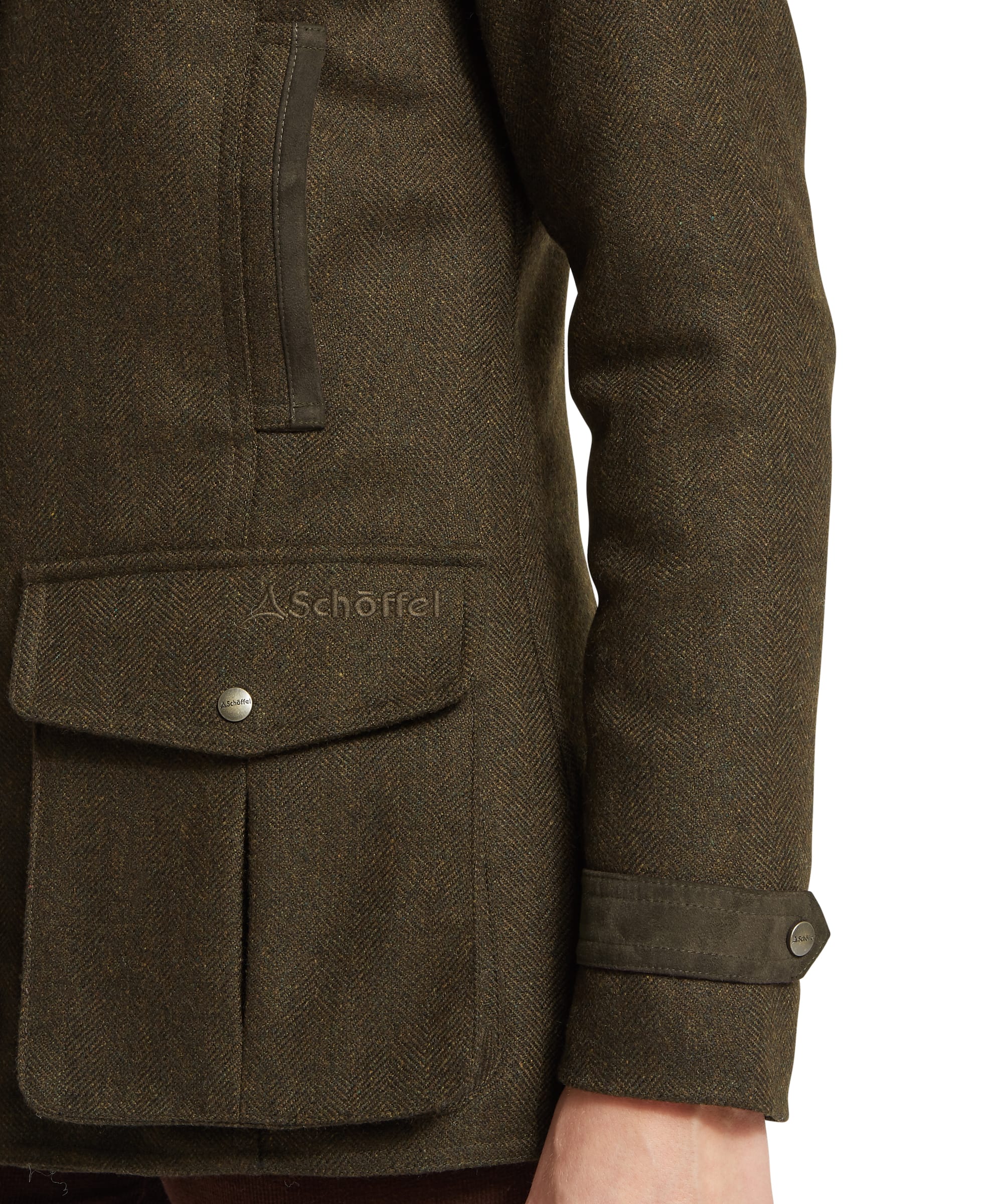 Close-up of the snap-fastened patch pocket, Schöffel branded button and wax-trim cuff detail on the Women's Murra Tweed Coat in Dark Olive Herringbone, highlighting the rich herringbone weave and contrast wax cotton trim