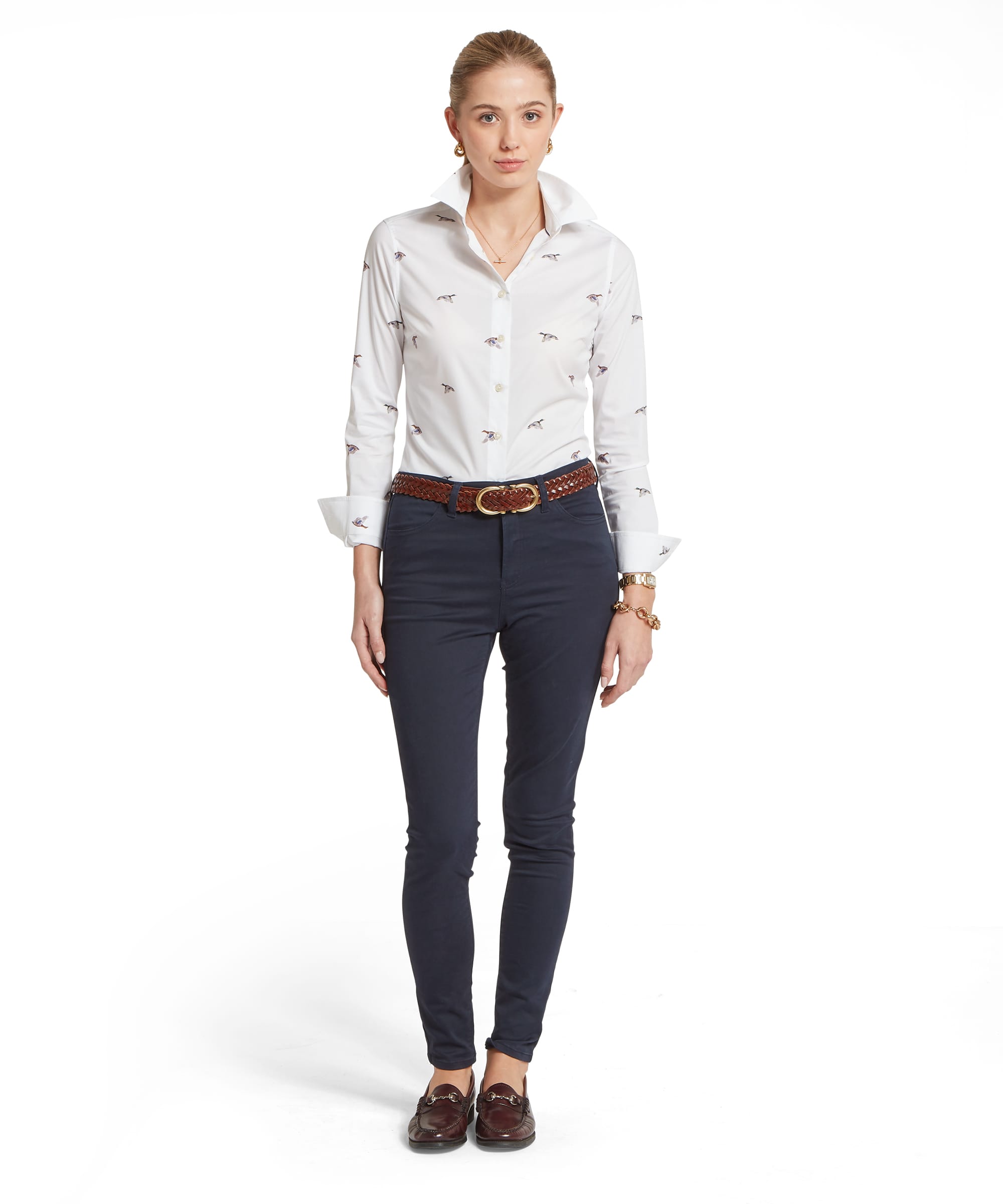 Full-length view of the Women's Schöffel Norfolk Shirt in white flying duck print, tucked into slim-fit navy cord trousers with a tan plaited leather belt and dark brown horsebit loafers.