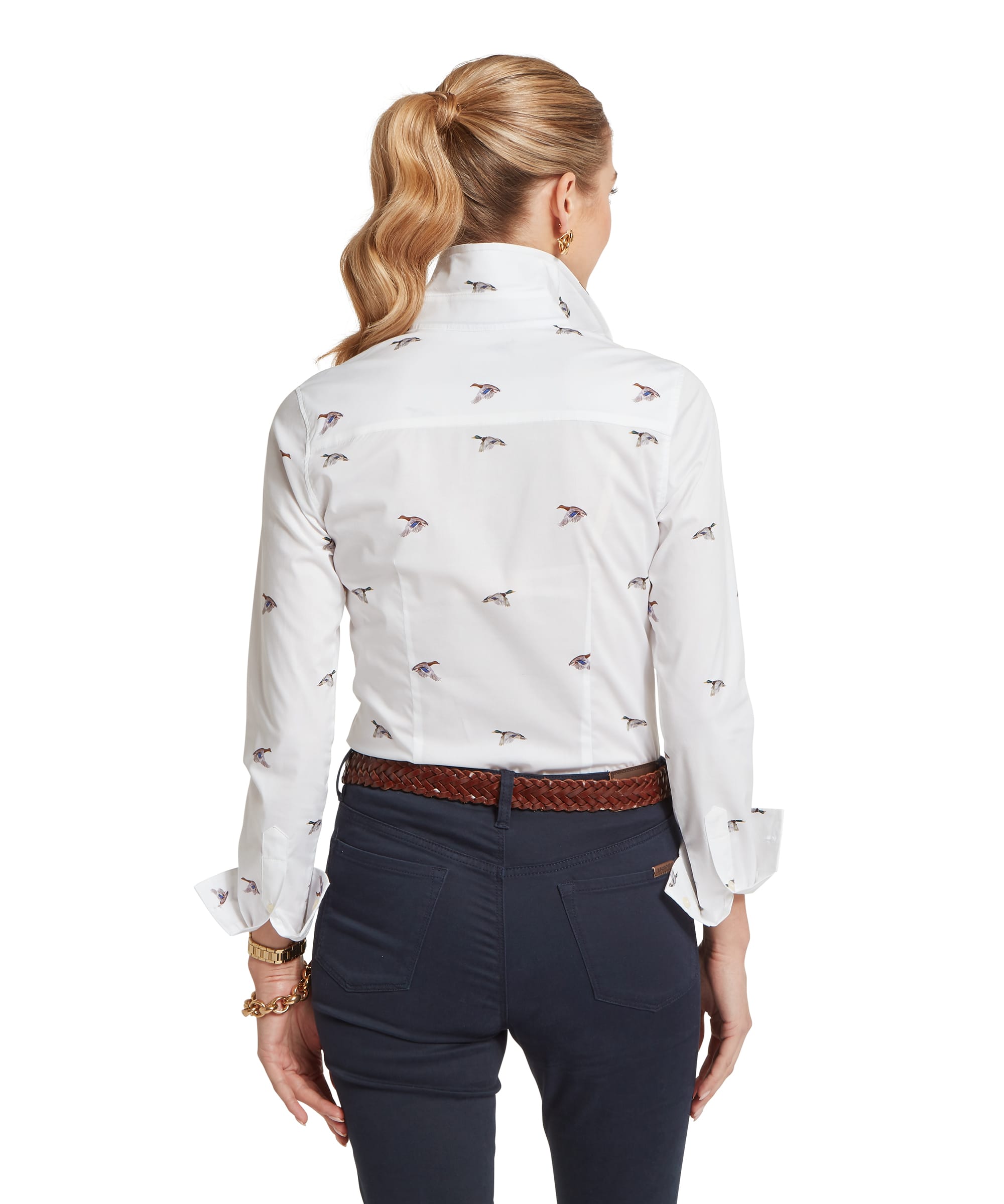 Rear view of a woman wearing a white Norfolk shirt with a duck pattern and dark pants on a white background
