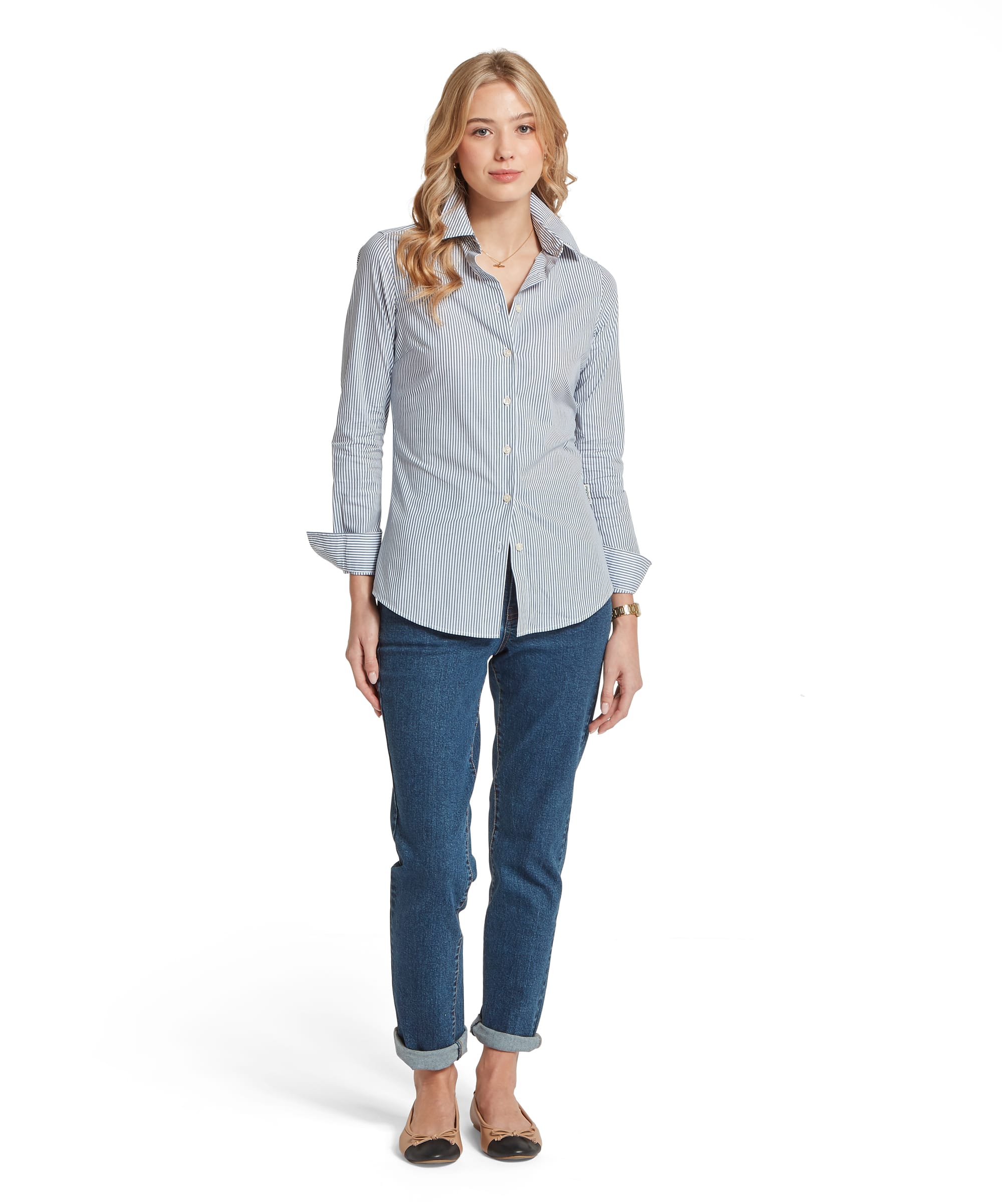 Woman wearing a light blue button-up shirt and jeans on a white background
