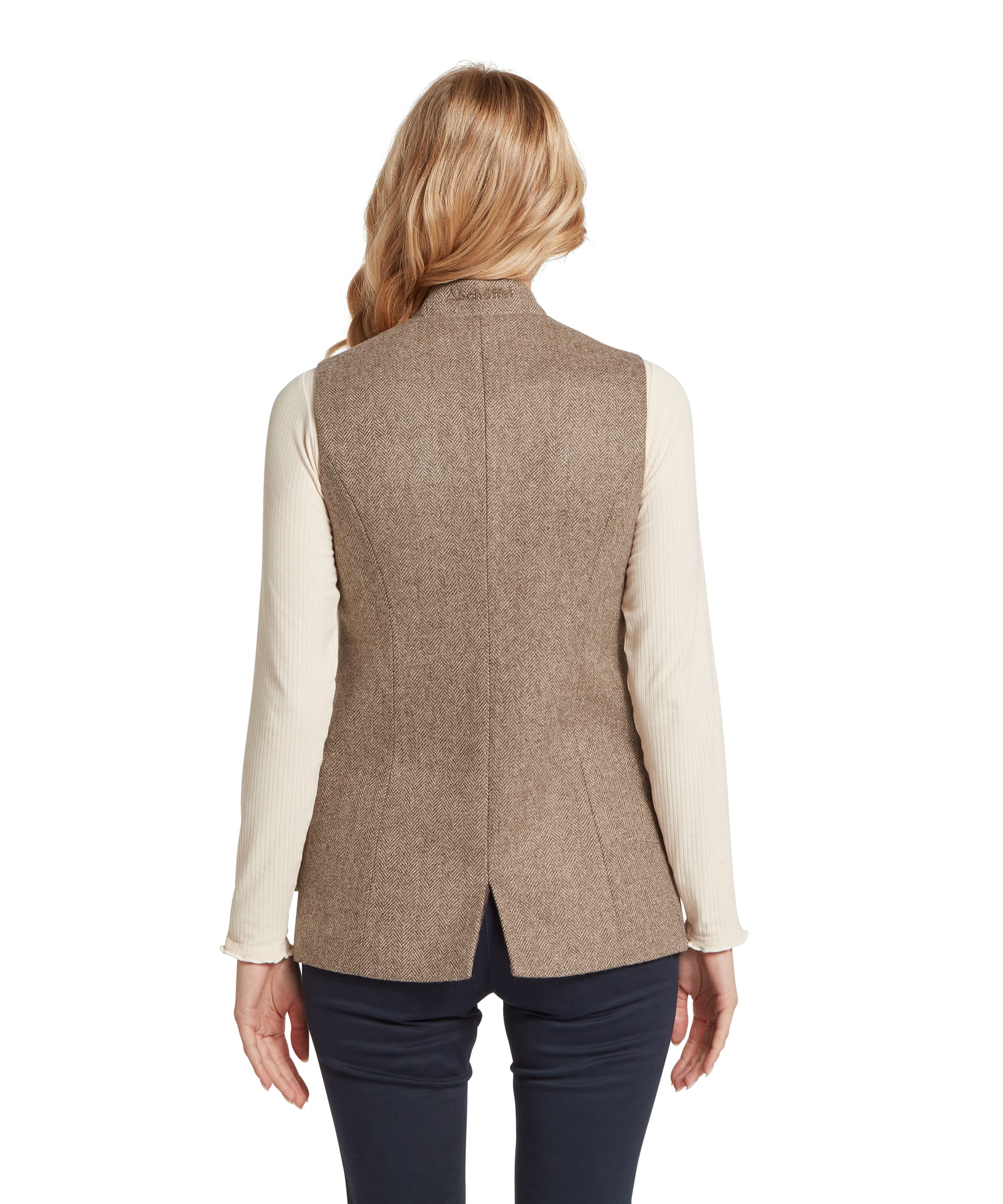 Schöffel Women's Pennan Tweed Waistcoat in grey herringbone tweed, rear view showing the fitted back panel, centre back seam, short vent, and tonal Schöffel embroidery at the back neck, worn over a cream ribbed long-sleeve top with navy trousers