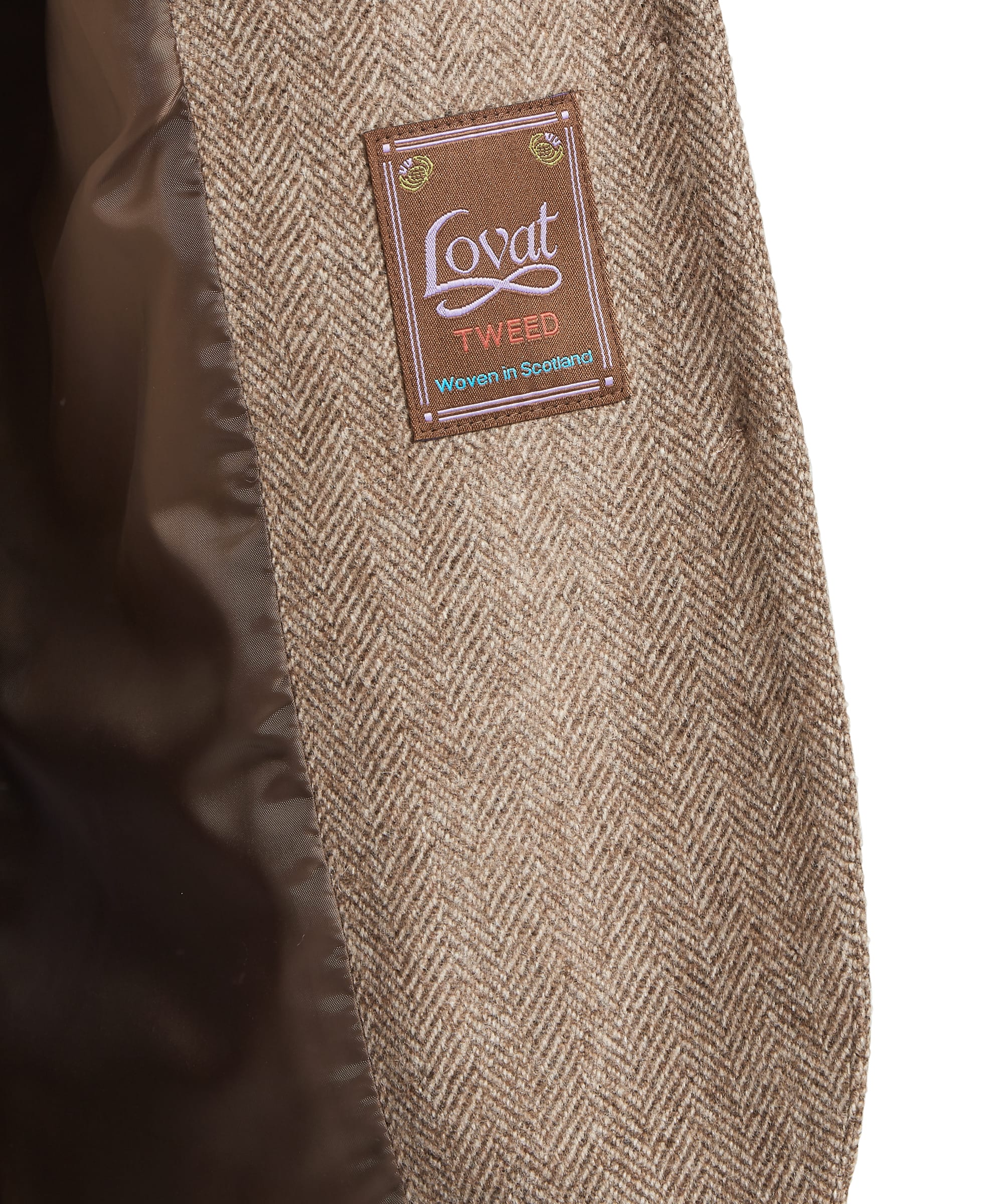 Schöffel Women's Pennan Tweed Waistcoat — close-up of Lovat Tweed label showing the herringbone weave fabric woven in Scotland, with satin lining detail