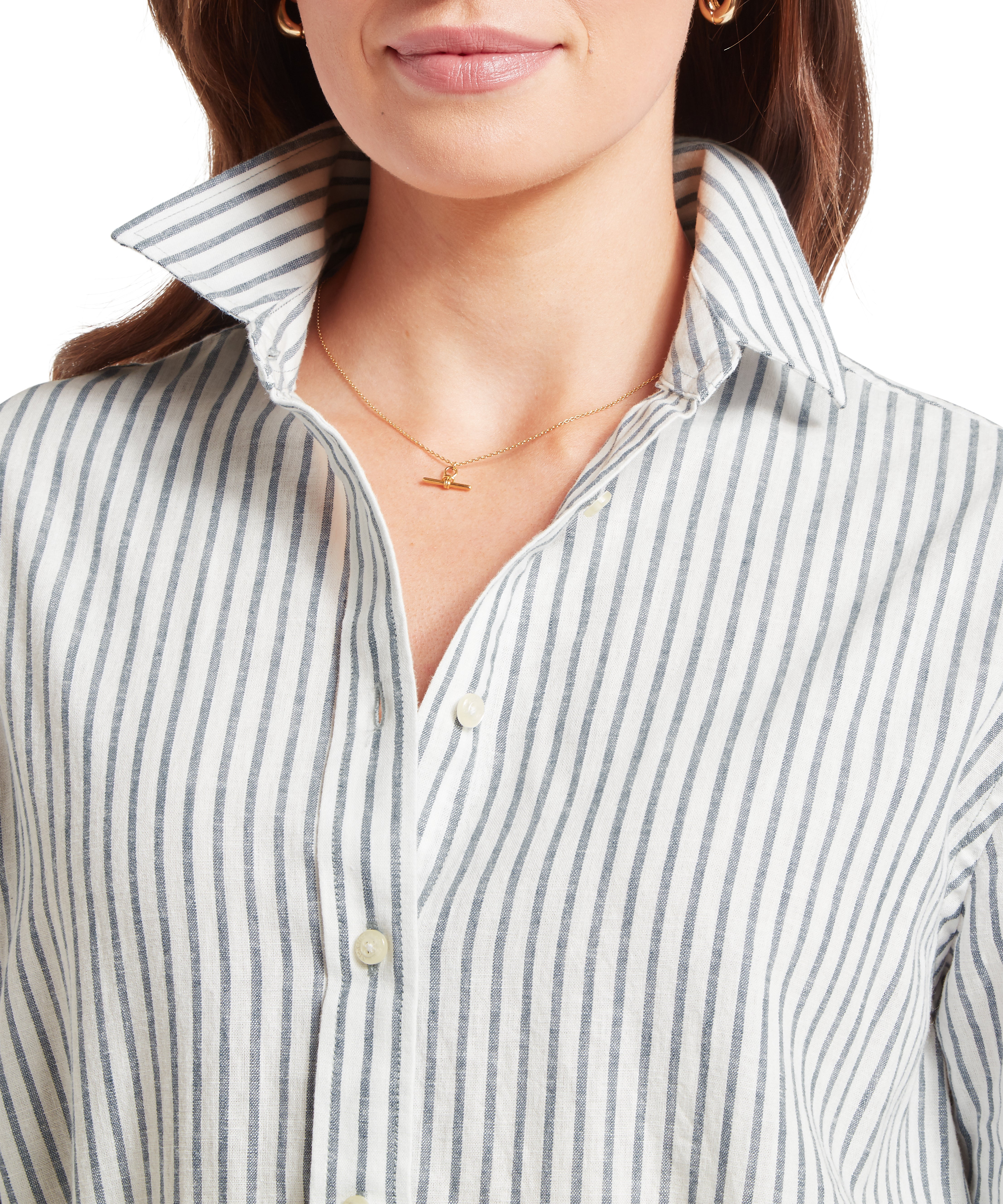 Close-up of a person wearing a striped shirt with a necklace.