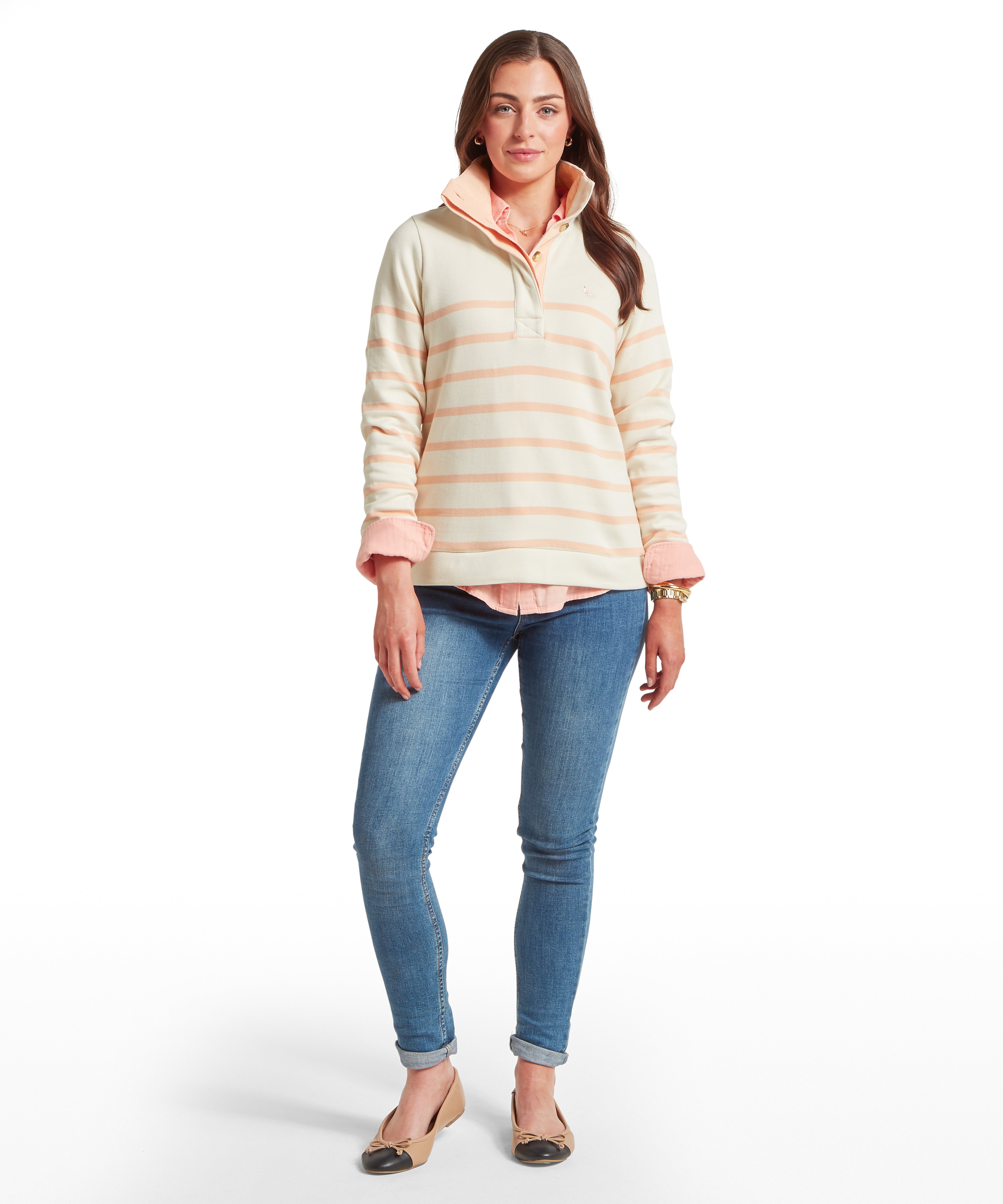 Woman wearing a striped long-sleeve sweatshirt and blue jeans on a white background