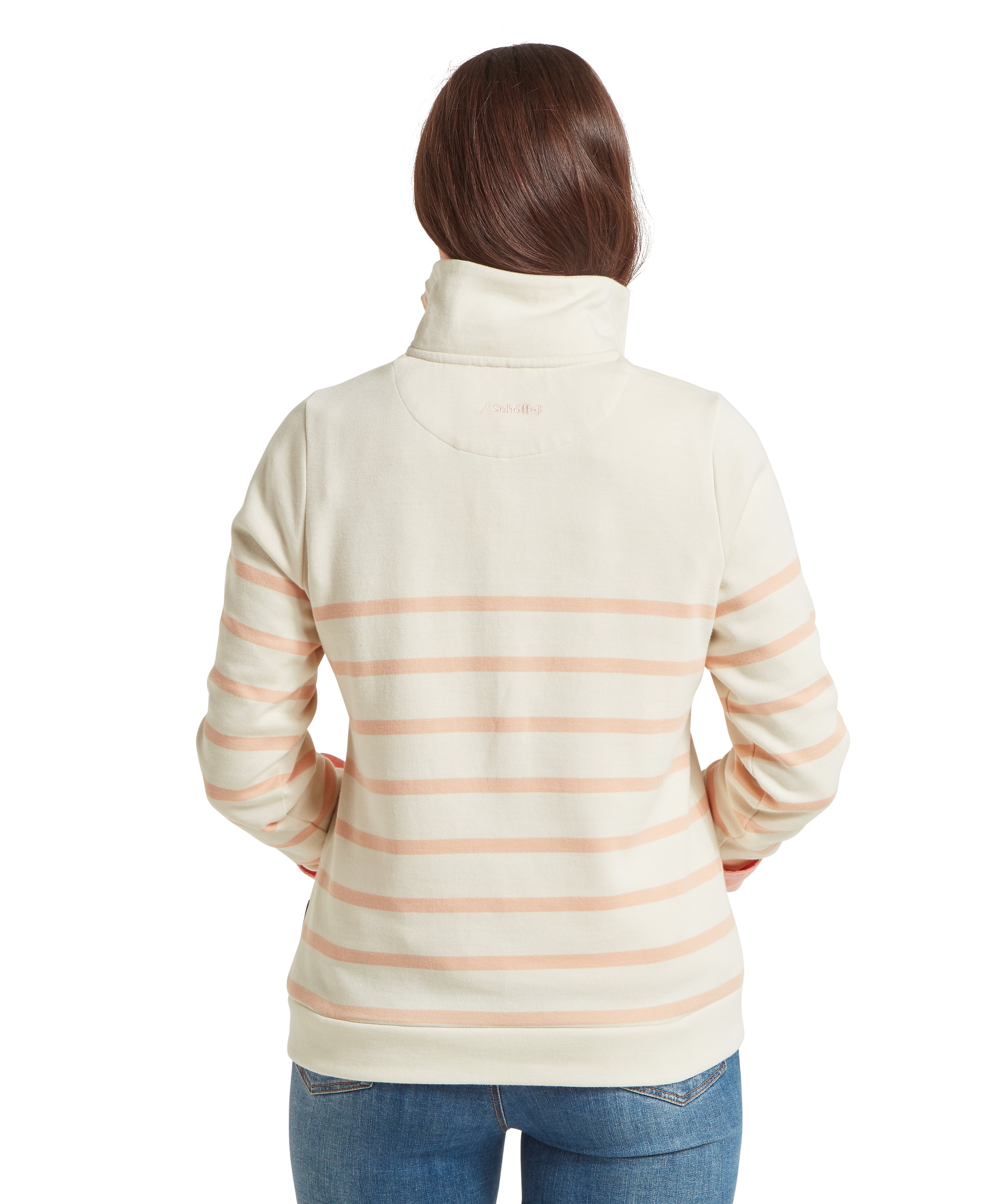 Person wearing a cream and pink striped sweatshirt facing backwards against a white background
