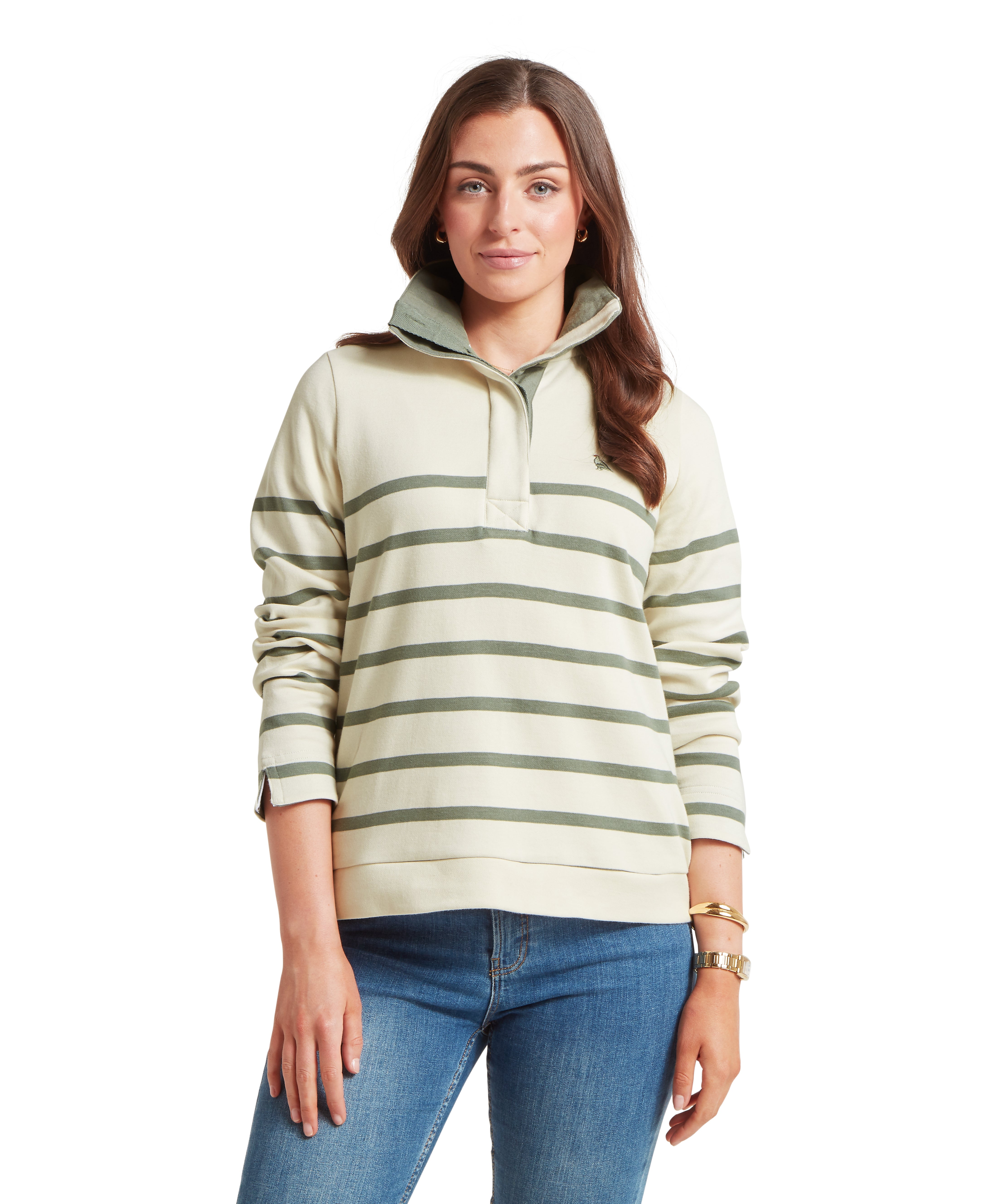 Woman wearing a striped cream and green sweatshirt paired with blue jeans on a white background