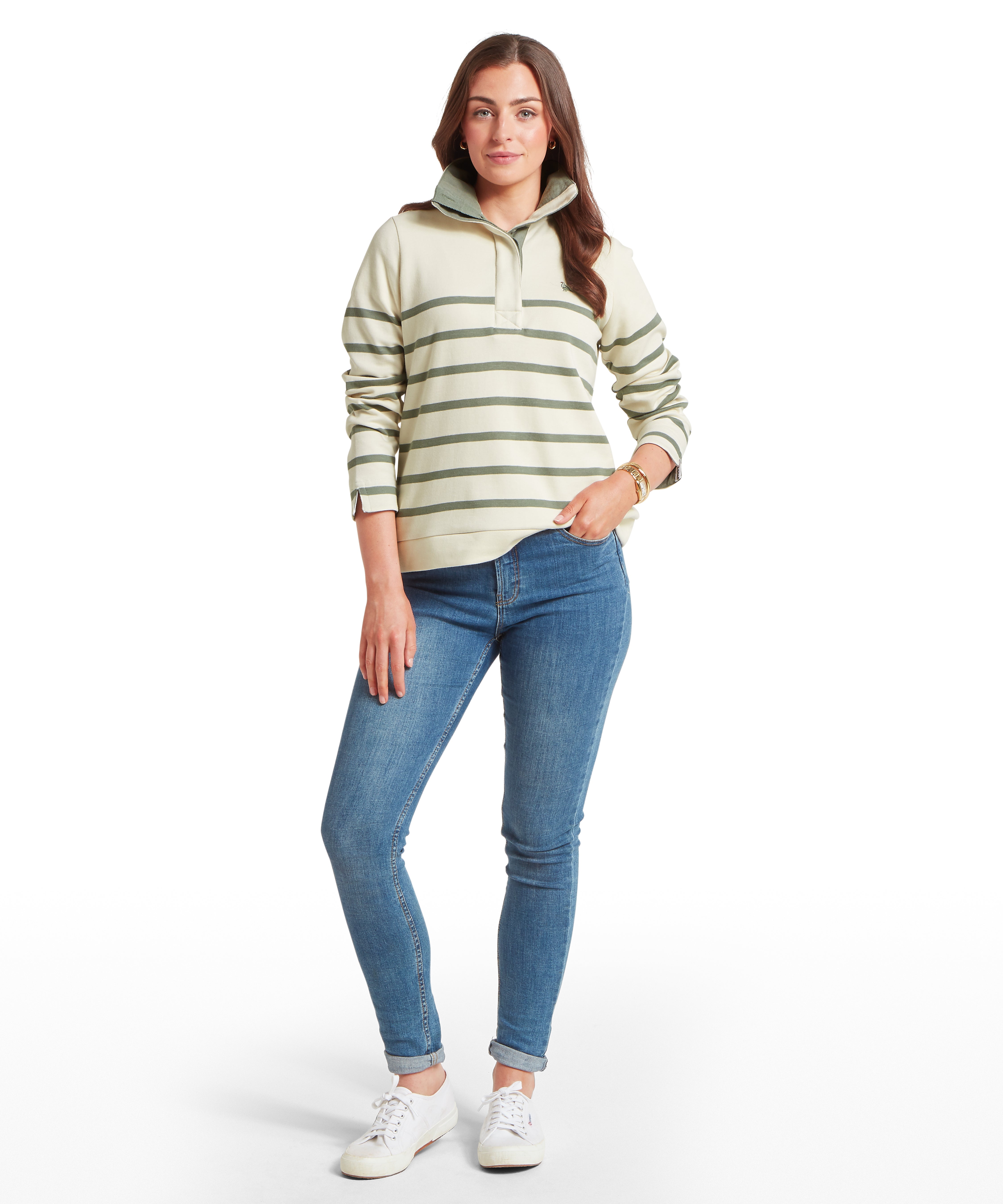 Woman wearing a striped sweater and blue jeans on a white background