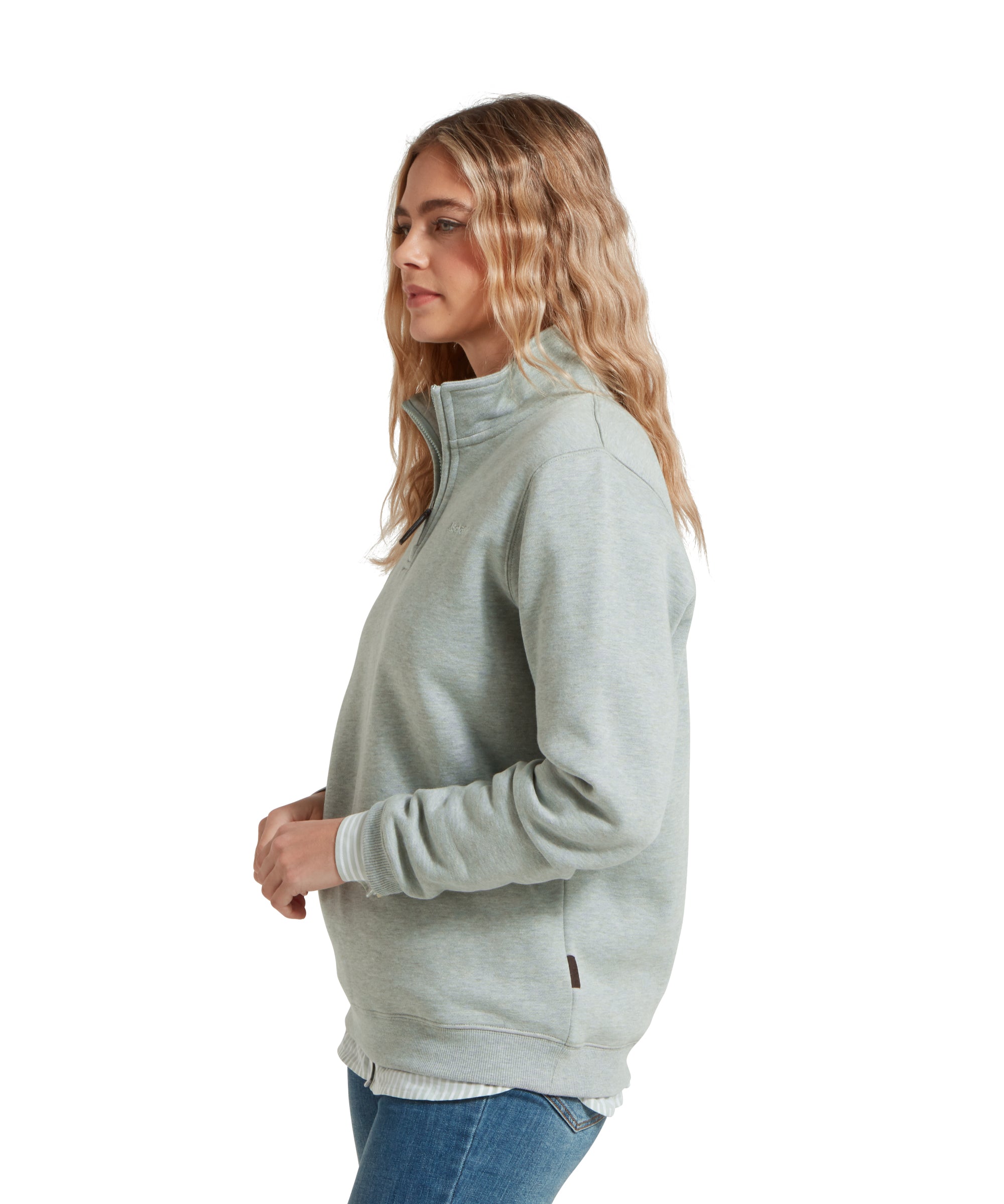 Side profile of a woman wearing a Schöffel Sennen Cove Sweatshirt for Women in Light Blue, slightly turned to her left, smiling.