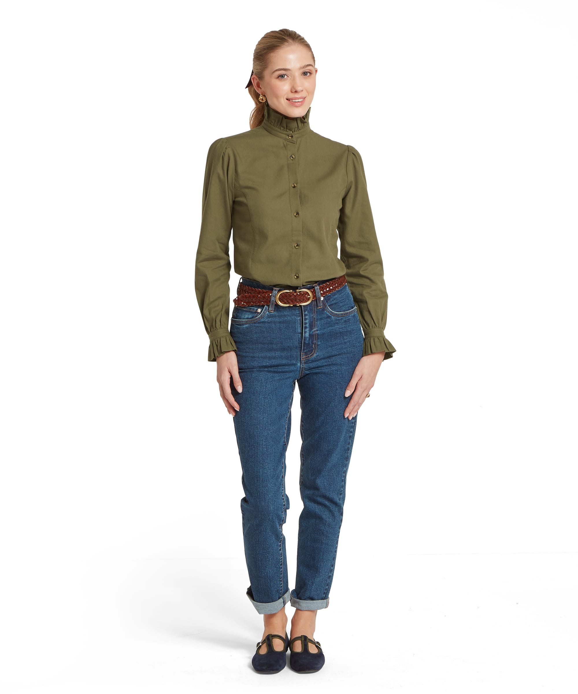 Full-length front view of the Schöffel Women's Sheringham Shirt in Khaki Green, showing the fitted silhouette with puff sleeves, ruffled collar and antique brass buttons, worn with turn-up blue jeans and navy ballet flats