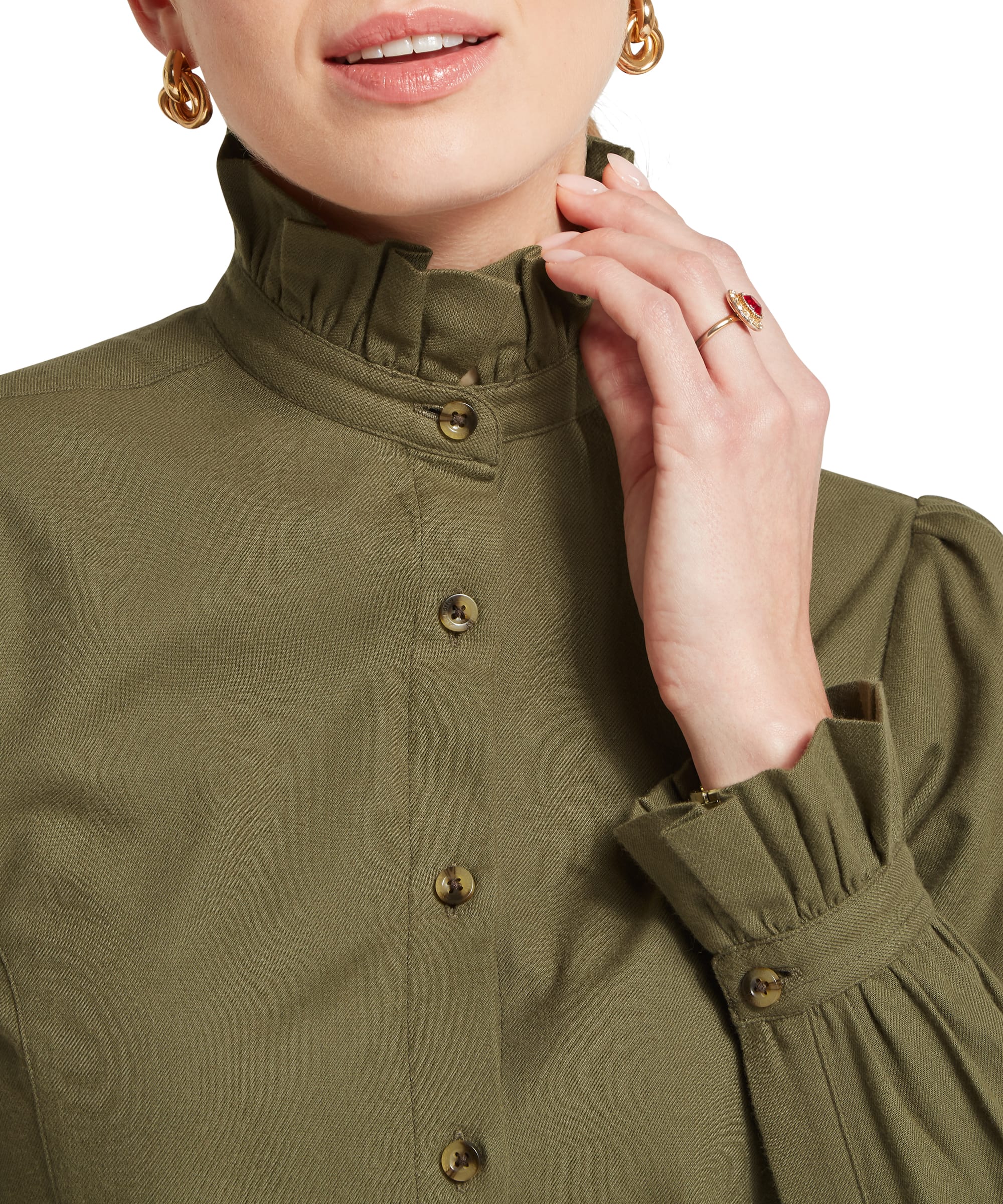 Close-up of the ruffled stand collar and puff-sleeve cuff on the Schöffel Women's Sheringham Shirt in Khaki Green, highlighting the antique brass buttons and heritage twill fabric