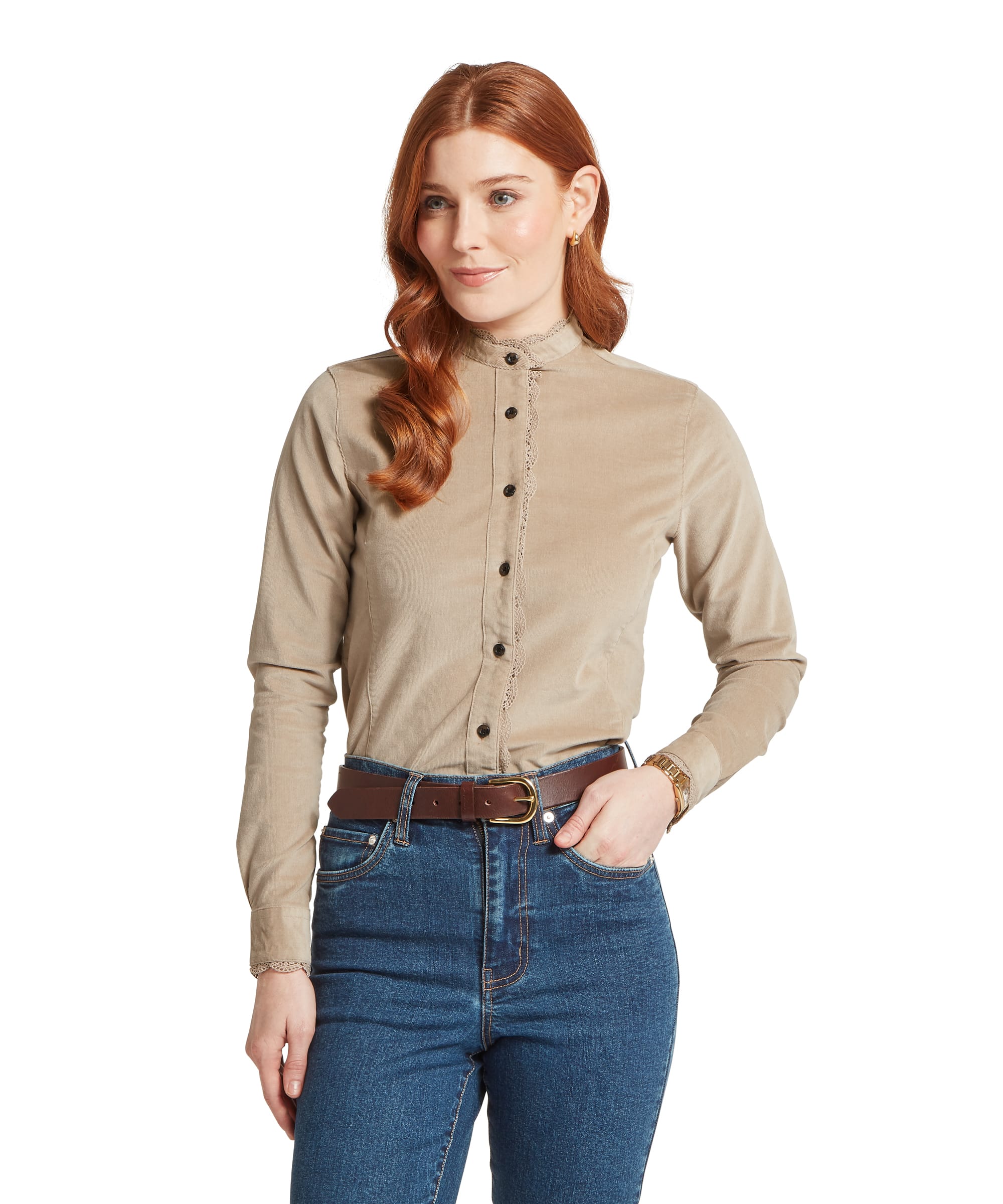 Woman wearing the Schöffel Women's Thetford Cord Shirt in Stone, showing the fitted silhouette, decorative lace-trim button placket and stand collar, styled with dark blue jeans and a tan leather belt