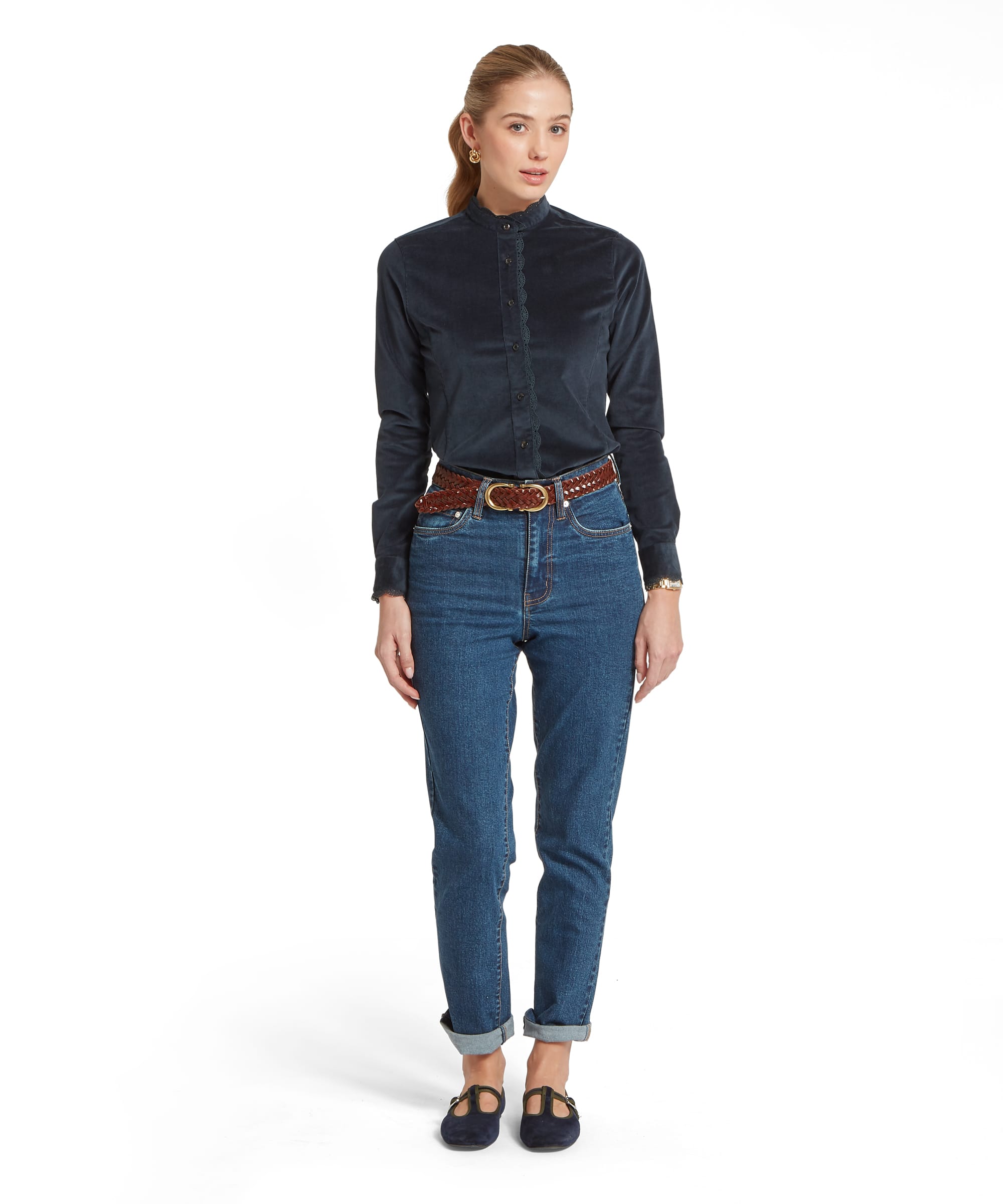 Full-length view of the Women's Schöffel Thetford Cord Shirt in midnight navy needlecord, with lace-trimmed standing collar and lace placket detail, tucked into relaxed-fit blue denim jeans with a tan plaited belt and navy velvet T-bar flats.