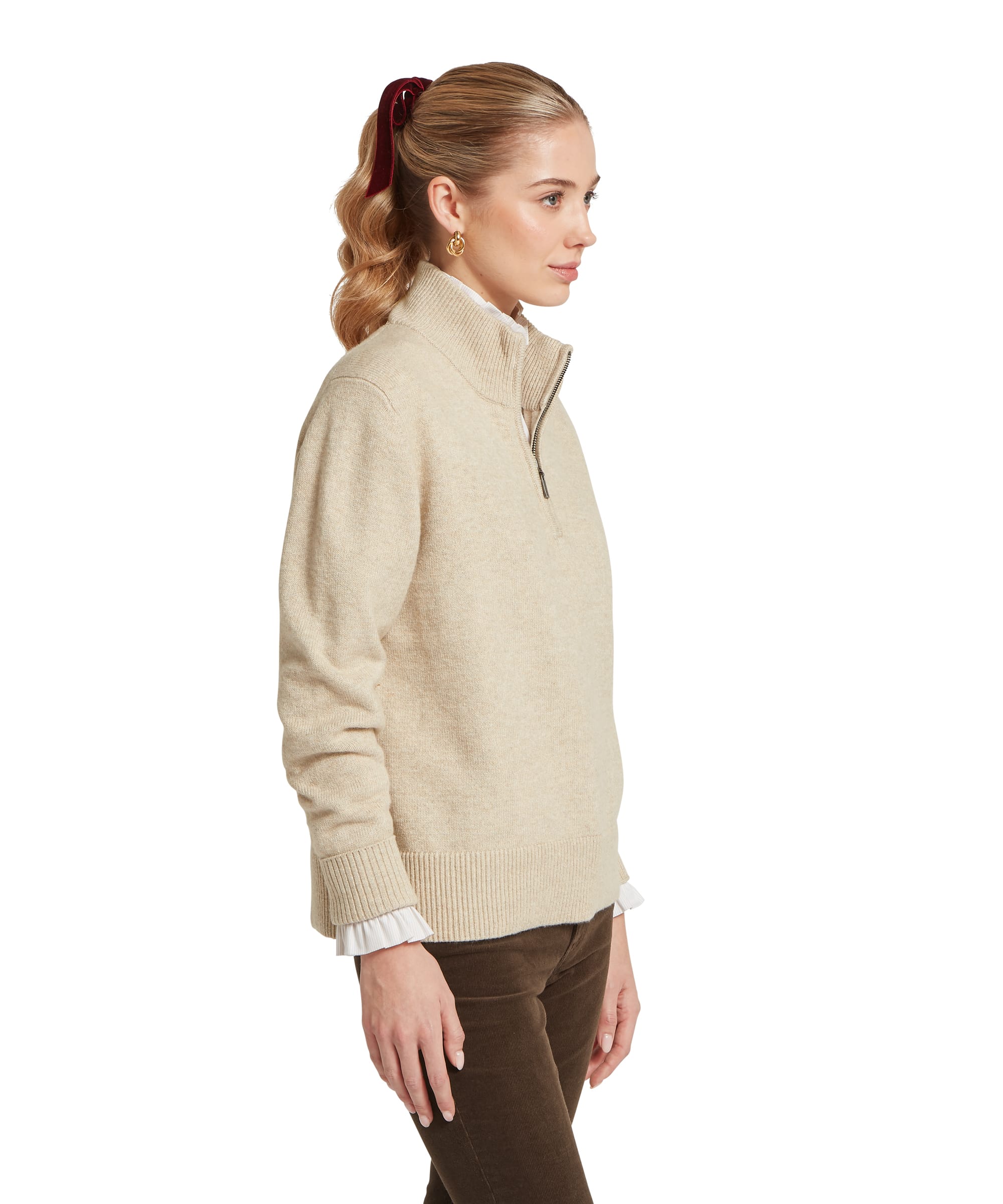 Schöffel Women's Thoralby 1/4 Zip Jumper in oatmeal cream, side view showing the relaxed boxy fit, ribbed hem and cuffs, and half-zip funnel neck with a white frill-collar shirt layered beneath, worn with dark chocolate cord trousers
