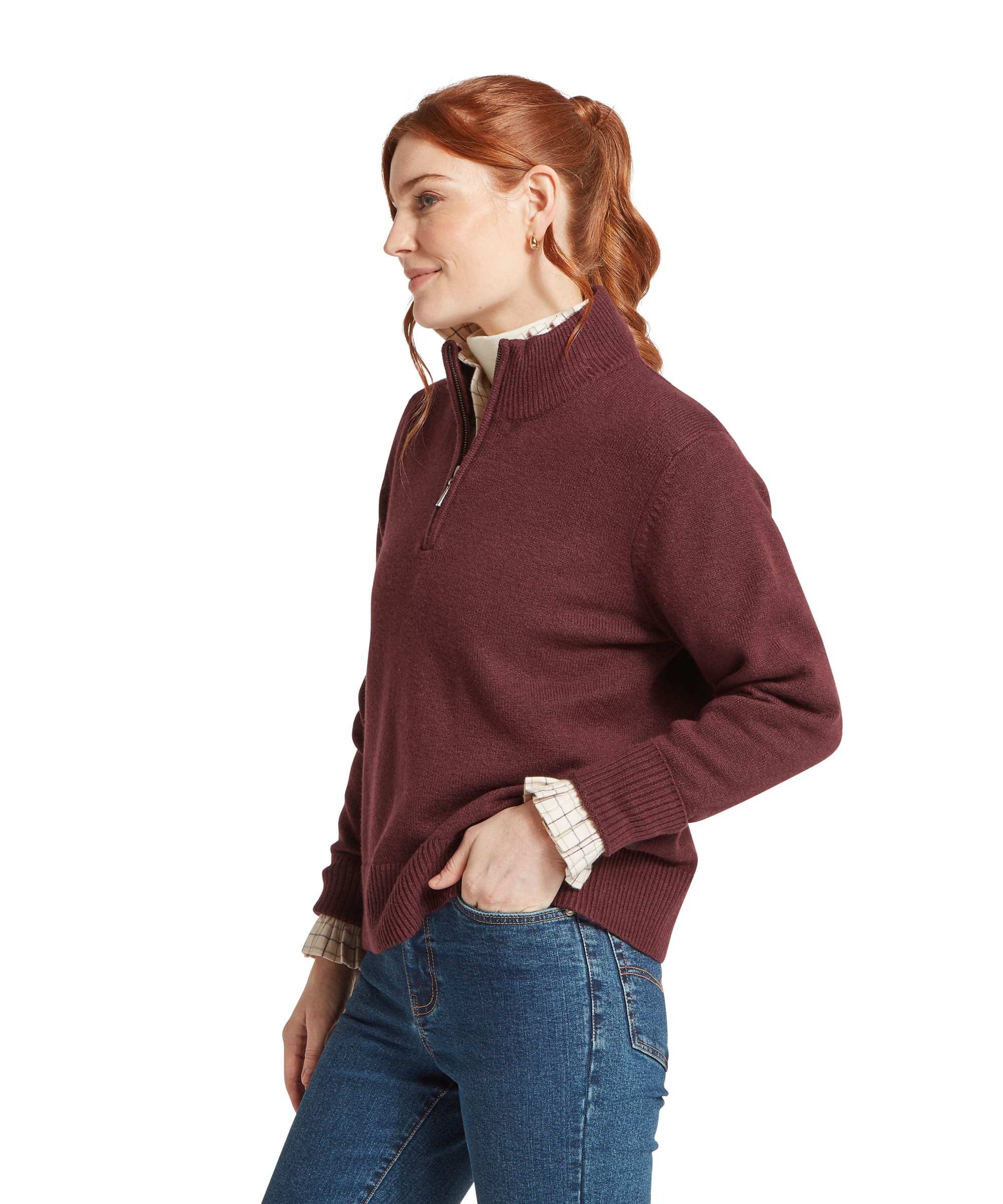 Schöffel Women's Thoralby 1/4 Zip Jumper in rich burgundy red, side view showing ribbed hem, cuffs and high-neck zip collar, styled with a classic check shirt and blue jeans