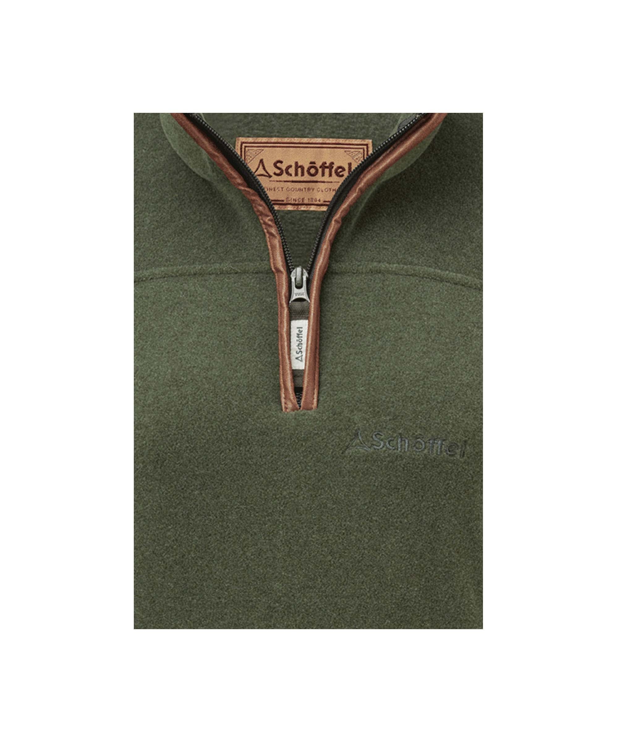 Schöffel Women's Tilton Quarter Zip Fleece in Dark Green close-up showing branded zip pull and tan leather-trim collar detail