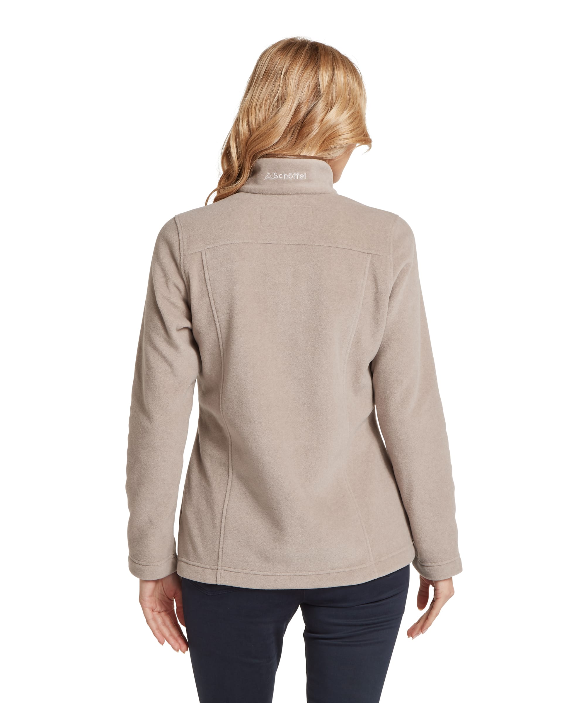 Rear view of the Women's Schöffel Tilton II Quarter-Zip Fleece in stone beige, showing the fitted back seaming, tonal Schöffel logo embroidery at the back of the stand collar and the jacket's hip-length silhouette, worn with navy trousers.