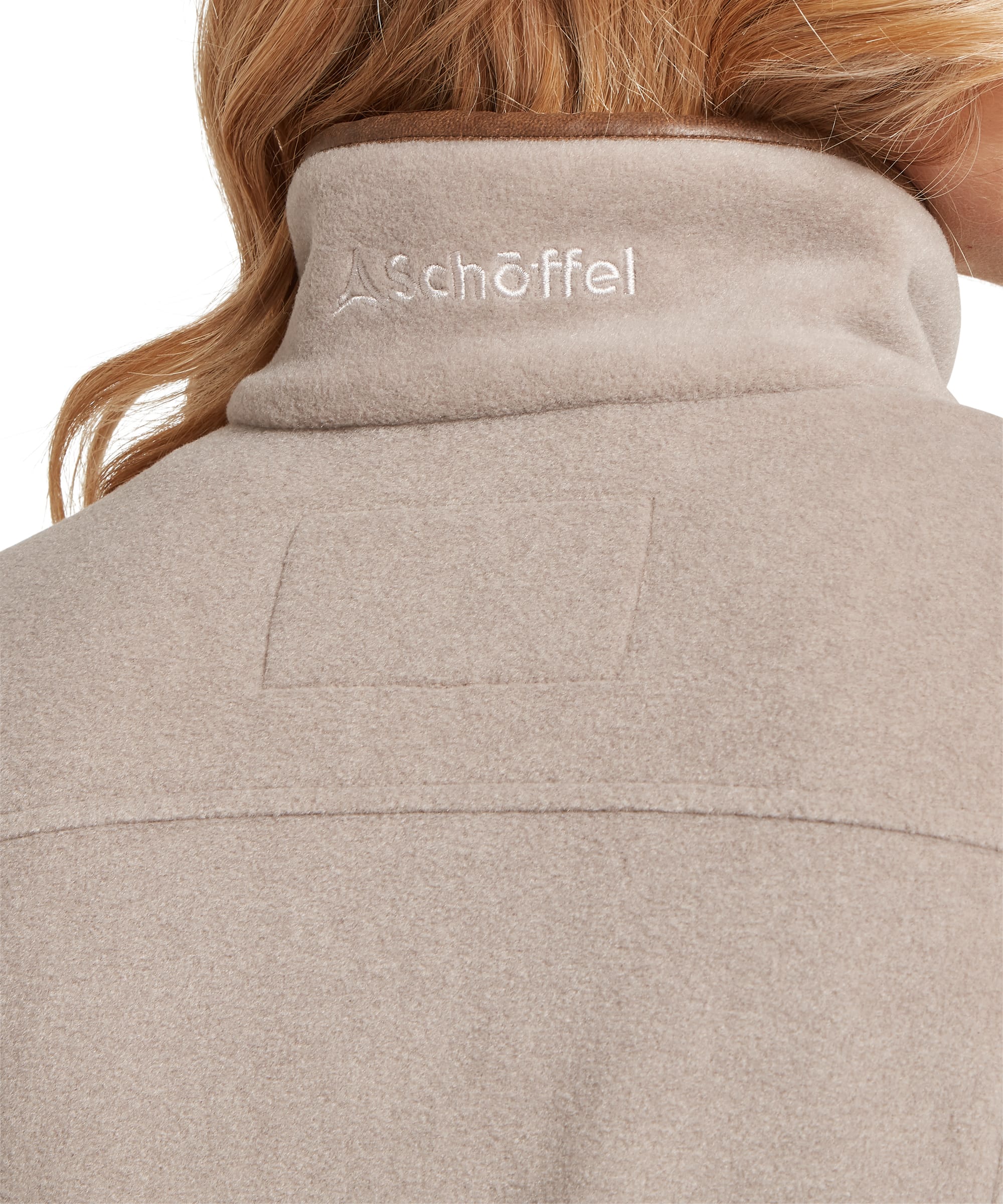 Close-up rear detail of the Women's Schöffel Tilton II Quarter-Zip Fleece in stone beige, highlighting the tonal Schöffel embroidered logo on the stand collar and the back yoke panel construction of the micro-fleece fabric.