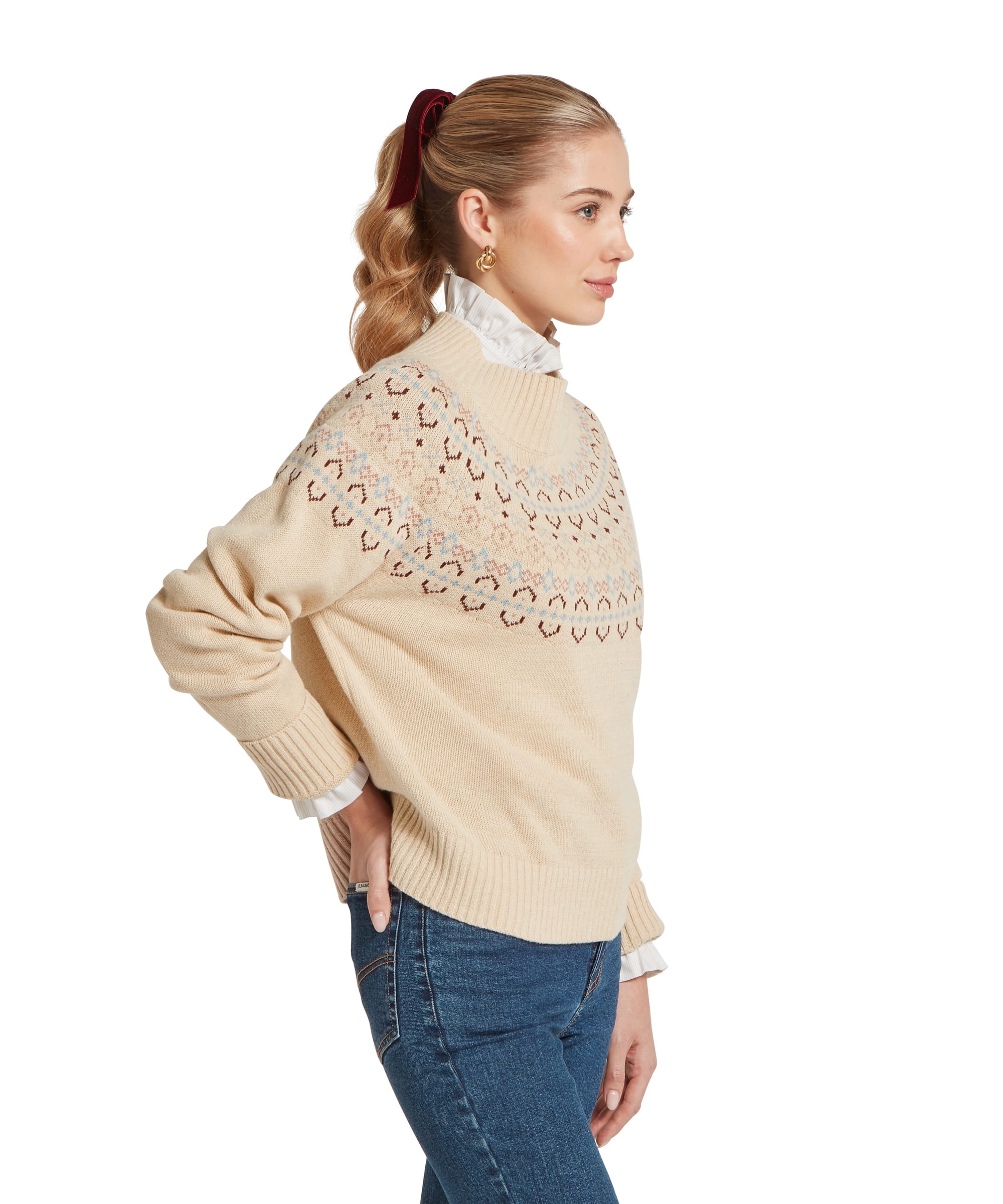 Schöffel Women's Tresness Fair Isle Jumper in cream with dusty blue, pink and burgundy fairisle yoke pattern, side view showing relaxed fit and ribbed cuffs, layered over a white frill-collar shirt with blue jeans