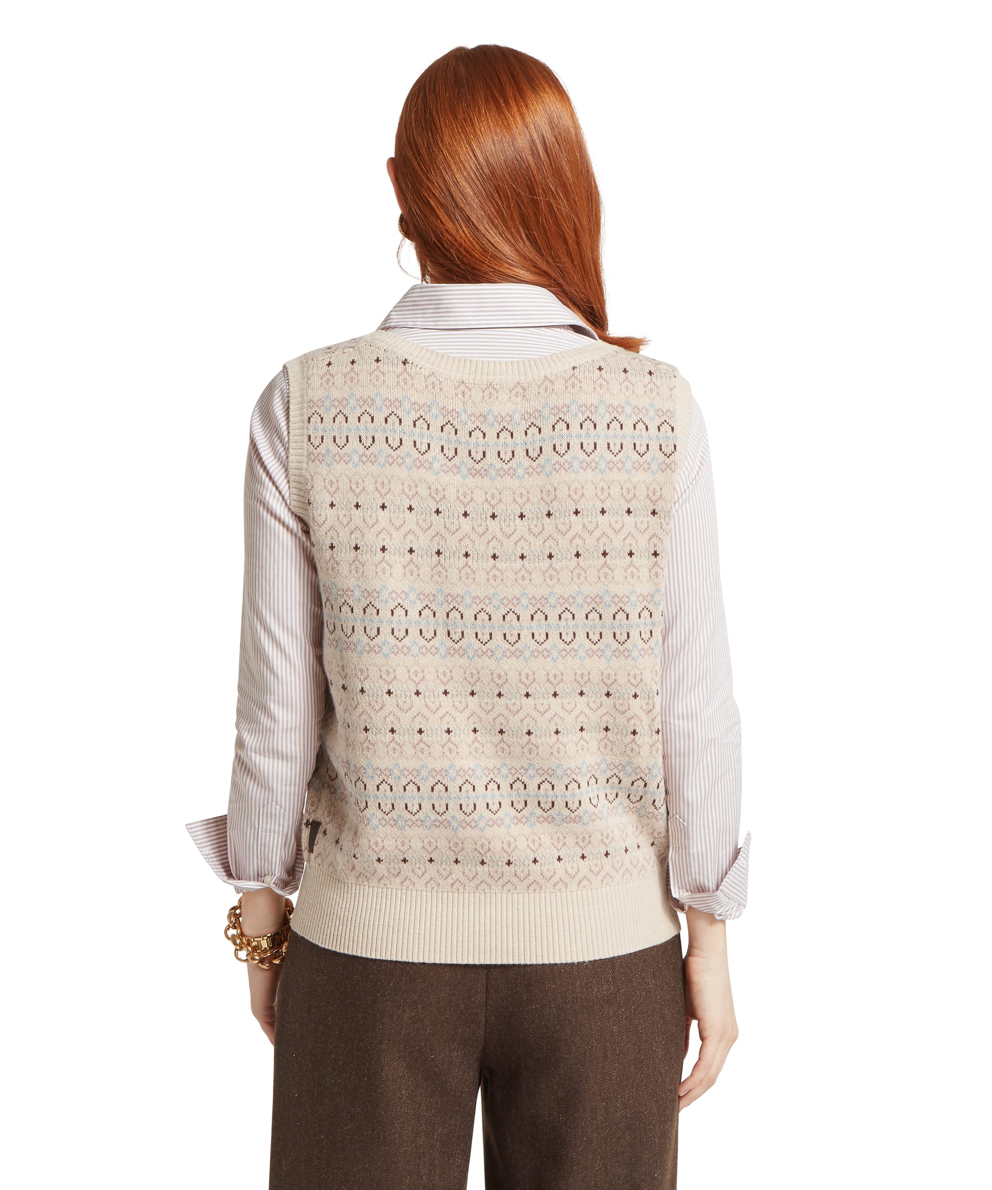 Schöffel Women's Tresness Fair Isle Vest in oatmeal cream, rear view showing the all-over fairisle knit design with ribbed back hem, layered over a striped shirt with wide-leg brown trousers